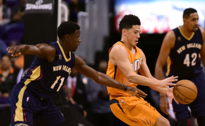Dec 11, 2016; Phoenix, AZ, USA; Phoenix Suns guard Devin Booker (1) reaches for the ball in front of New Orleans Pelicans guard Jrue Holiday (11) in the first half at Talking Stick Resort Arena. The New Orleans Pelicans won 120 - 119 in overtime. Mandatory Credit: Jennifer Stewart-USA TODAY Sports