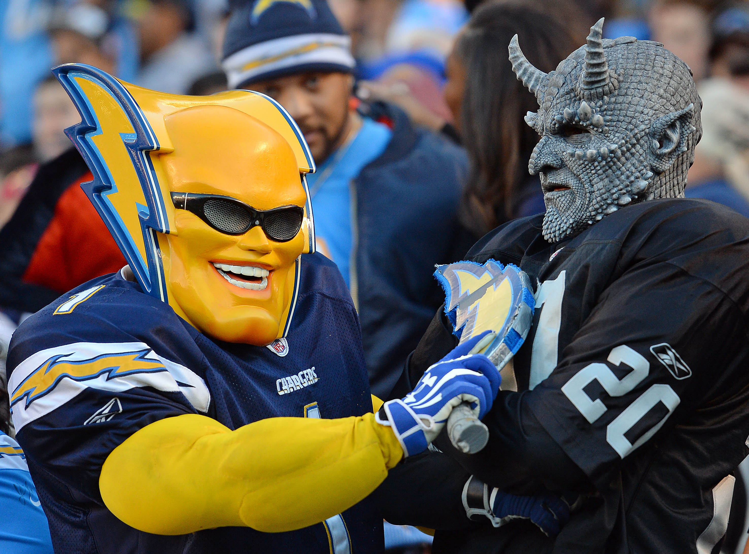Dec 18, 2016; San Diego, CA, USA; A San Diego Chargers fan and an Oakland Raiders fan oppose each other in the stands during the fourth quarter at Qualcomm Stadium. Mandatory Credit: Jake Roth-USA TODAY Sports