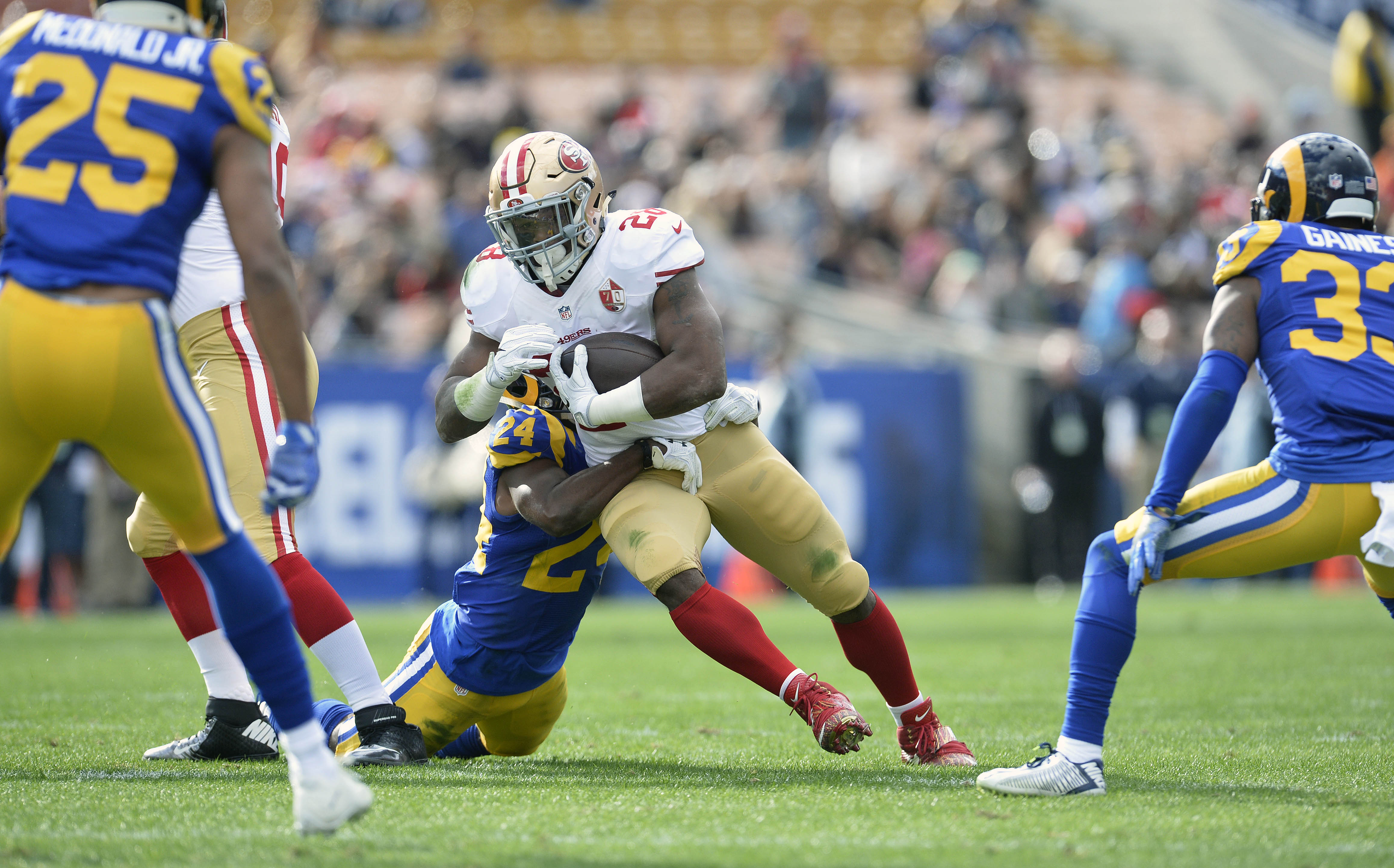 December 24, 2016; Los Angeles, CA, USA; San Francisco 49ers running back Carlos Hyde (28) runs the ball against the defense of Los Angeles Rams defensive back Blake Countess (24) during the first half at Los Angeles Memorial Coliseum. Mandatory Credit: Gary A. Vasquez-USA TODAY Sports