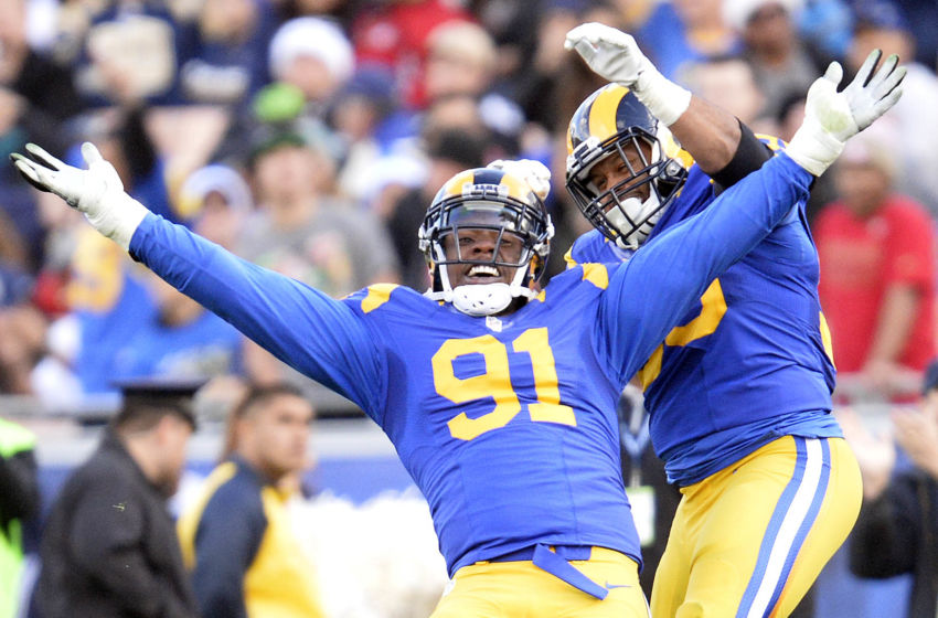 December 24, 2016; Los Angeles, CA, USA; Los Angeles Rams defensive tackle Dominique Easley (91) celebrates with defensive tackle Aaron Donald (99) after sacking San Francisco 49ers quarterback Colin Kaepernick (7) during the first half at Los Angeles Memorial Coliseum. Mandatory Credit: Gary A. Vasquez-USA TODAY Sports