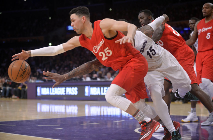 December 25, 2016; Los Angeles, CA, USA; Los Angeles Clippers guard Austin Rivers (25) reaches for the ball ahead of Los Angeles Lakers forward Thomas Robinson (15) during the second half at Staples Center. Mandatory Credit: Gary A. Vasquez-USA TODAY Sports