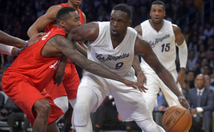 December 25, 2016; Los Angeles, CA, USA; Los Angeles Lakers forward Luol Deng (9) moves the ball against the defense of Los Angeles Clippers guard Jamal Crawford (11) during the second half at Staples Center. Mandatory Credit: Gary A. Vasquez-USA TODAY Sports