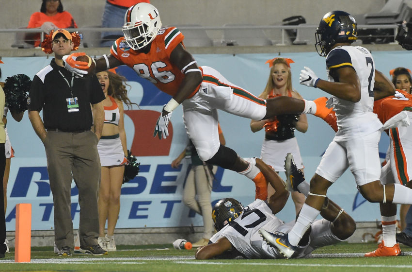 Dec 28, 2016; Orlando, FL, USA; Miami Hurricanes tight end David Njoku (86) dives for the end zone to score a touchdown against the West Virginia Mountaineers during the second half at Camping World Stadium. The Miami Hurricanes defeat the West Virginia Mountaineers 31-14. Mandatory Credit: Jasen Vinlove-USA TODAY Sports