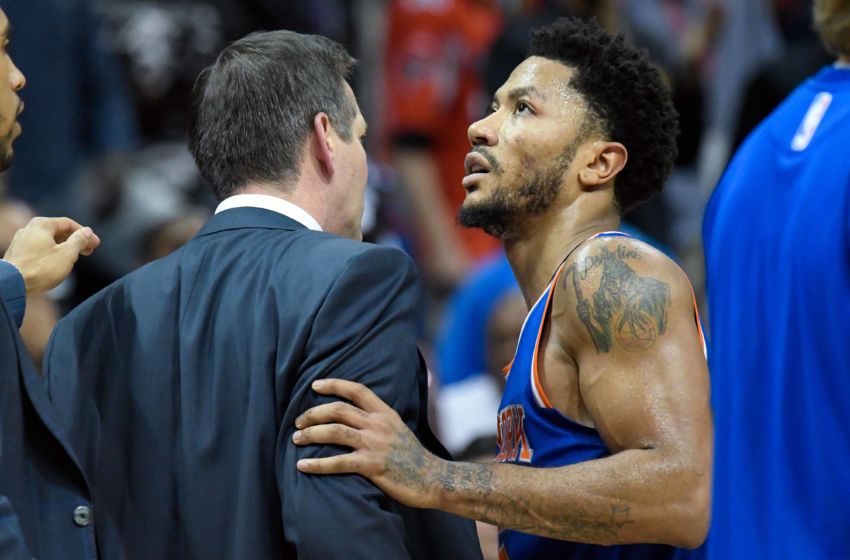 Dec 28, 2016; Atlanta, GA, USA; New York Knicks head coach Jeff Hornacek (left) is restrained by guard Derrick Rose (25) after reacting to a call during the game against the Atlanta Hawks during the overtime at Philips Arena. The Hawks defeated the Knicks 102-98 in overtime. Mandatory Credit: Dale Zanine-USA TODAY Sports