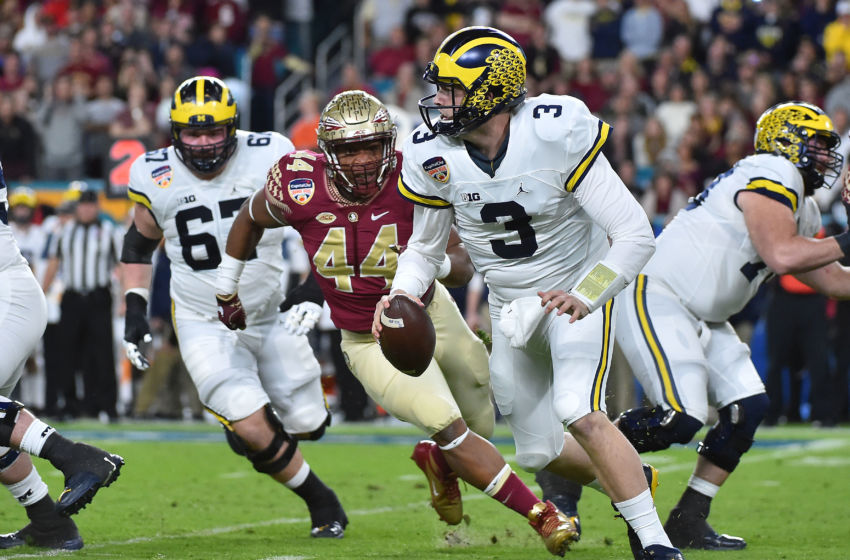 Dec 30, 2016; Miami Gardens, FL, USA; Michigan Wolverines quarterback Wilton Speight (3) scrambles under pressure from Florida State Seminoles defensive end DeMarcus Walker (44) during the first half at Hard Rock Stadium. Mandatory Credit: Jasen Vinlove-USA TODAY Sports