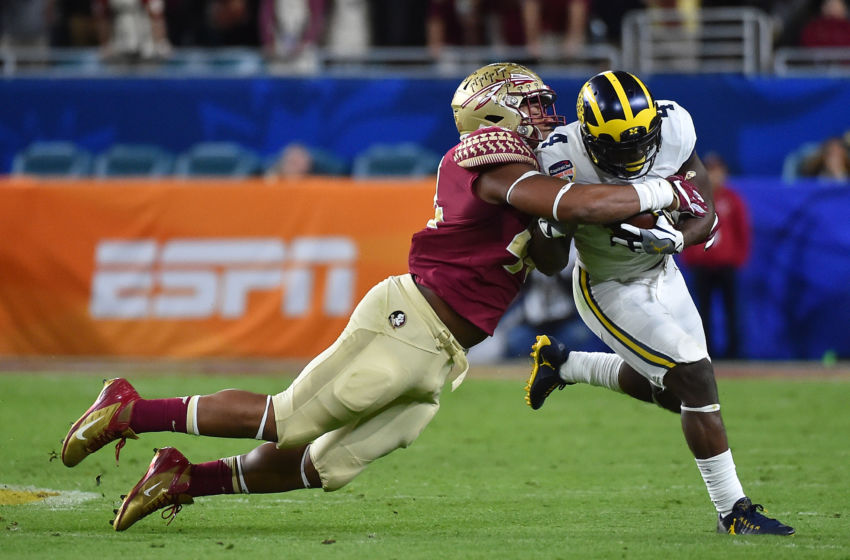 Dec 30, 2016; Miami Gardens, FL, USA; Florida State Seminoles defensive end DeMarcus Walker (44) tackles Florida State Seminoles running back Dalvin Cook (4) during the first half at Hard Rock Stadium. Mandatory Credit: Jasen Vinlove-USA TODAY Sports