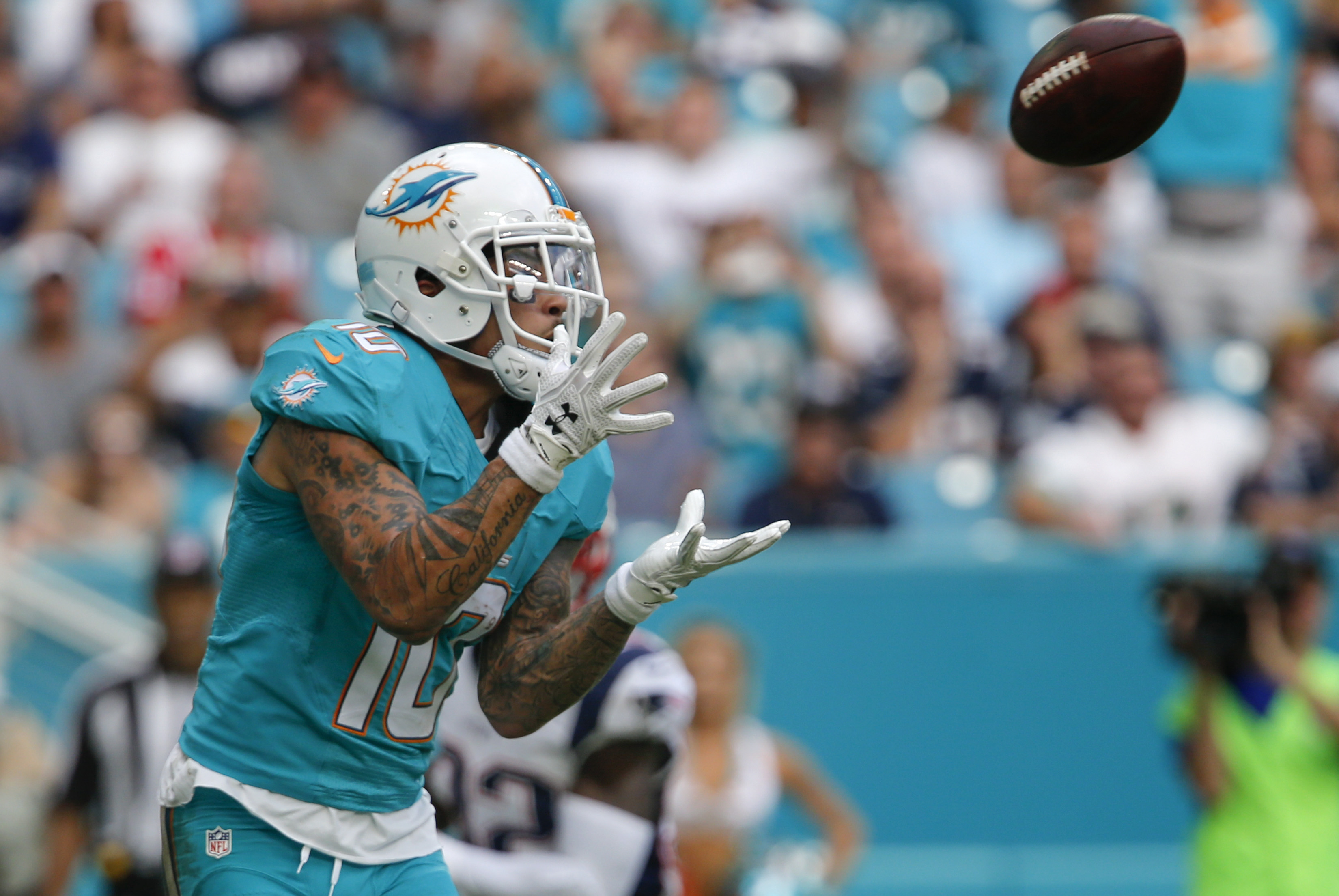 Jan 1, 2017; Miami Gardens, FL, USA; Miami Dolphins wide receiver Kenny Stills (10) catches a touchdown pass during the second half of an NFL football game against the New England Patriots at Hard Rock Stadium. The Patriots won 35-14. Mandatory Credit: Reinhold Matay-USA TODAY Sports