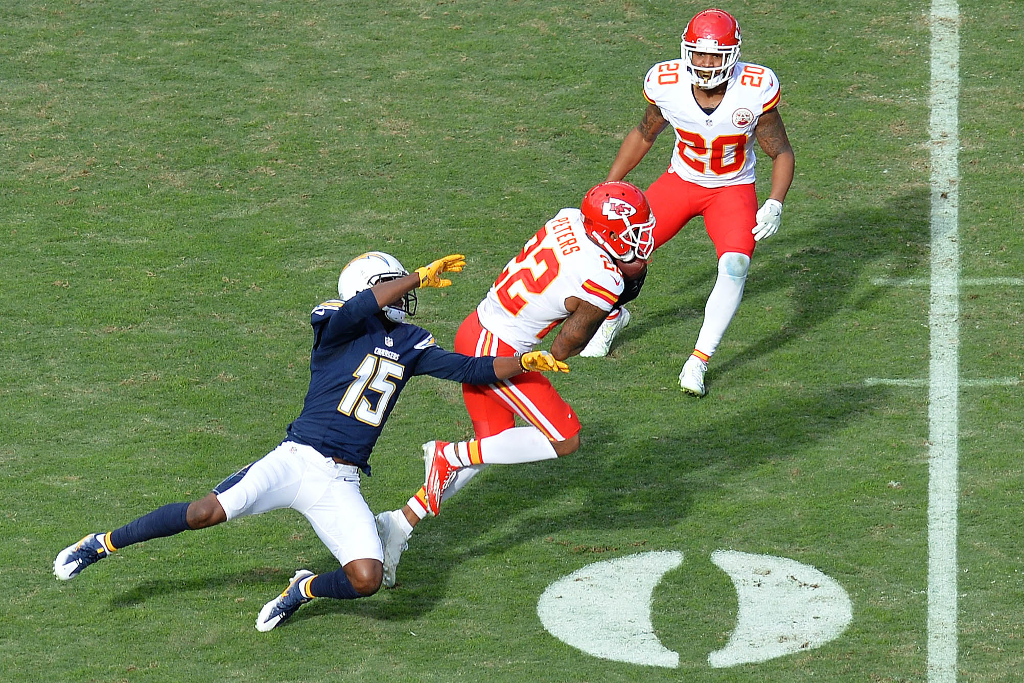 Jan 1, 2017; San Diego, CA, USA; Kansas City Chiefs cornerback Marcus Peters (22) intercepts a pass intended for San Diego Chargers wide receiver Dontrelle Inman (15) as cornerback Steven Nelson (20) assists in defense during the second quarter at Qualcomm Stadium. Mandatory Credit: Jake Roth-USA TODAY Sports
