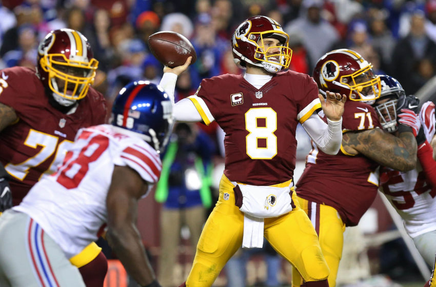 Jan 1, 2017; Landover, MD, USA; Washington Redskins quarterback Kirk Cousins (8) throws the ball as New York Giants defensive end Owa Odighizuwa (58) chases in the third quarter at FedEx Field. The Giants won 19-10. Mandatory Credit: Geoff Burke-USA TODAY Sports