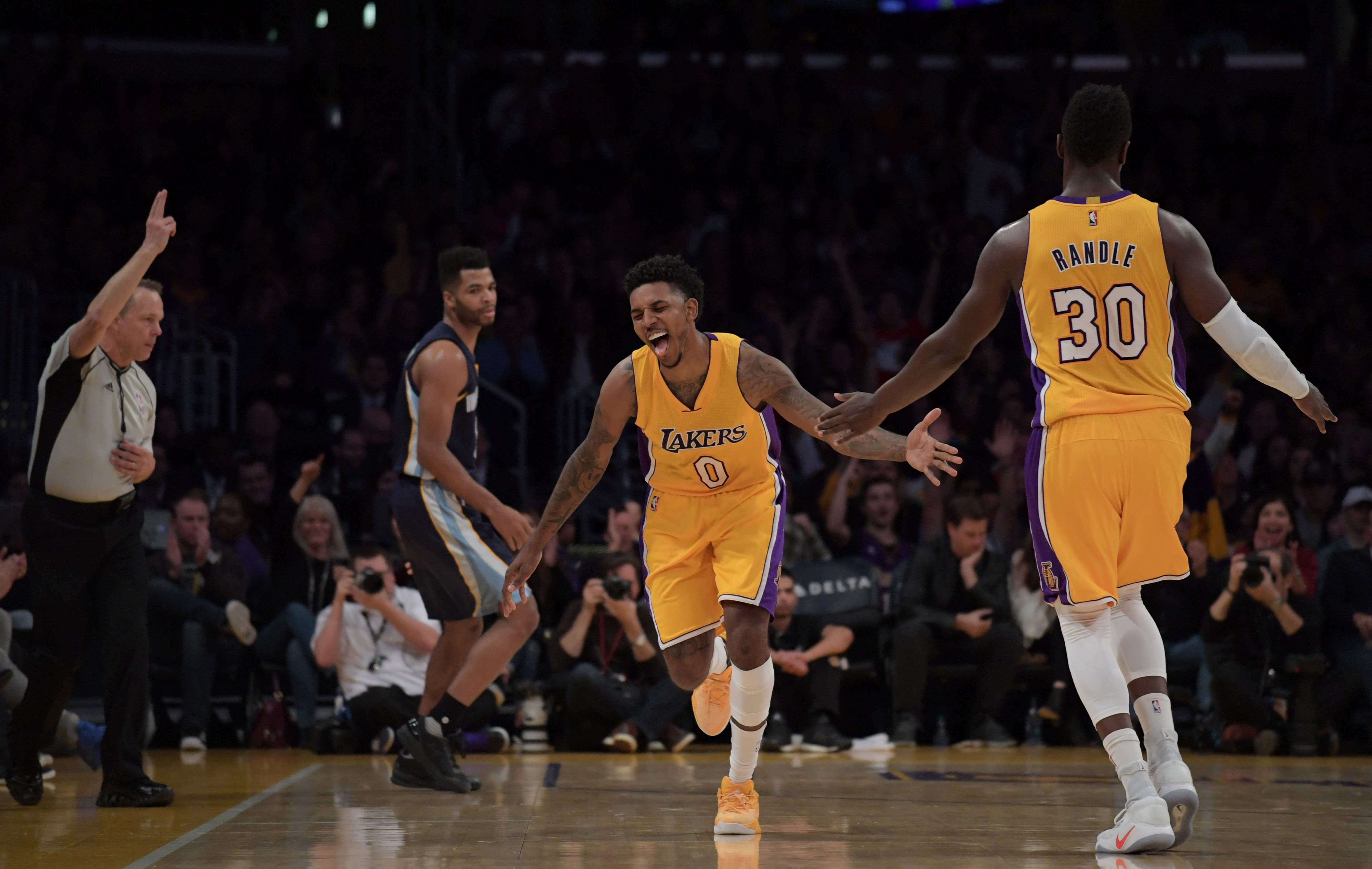 Jan 3, 2017; Los Angeles, CA, USA; Los Angeles Lakers guard Nick Young (0) is congratulated by Los Angeles Lakers forward Julius Randle (30) after a 3-point basket in the first half against the Memphis Grizzlies during a NBA game at Staples Center. Mandatory Credit: Kirby Lee-USA TODAY Sports