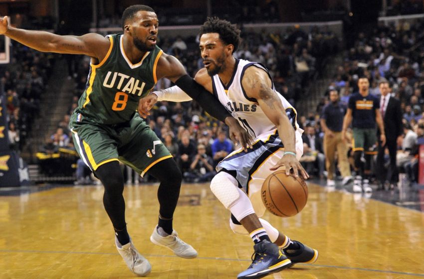 Jan 8, 2017; Memphis, TN, USA; Memphis Grizzlies guard Mike Conley (11) handles the ball against Utah Jazz guard Shelvin Mack (8) during the second half at FedExForum. Memphis Grizzlies defeats the Utah Jazz 88-79. Mandatory Credit: Justin Ford-USA TODAY Sports