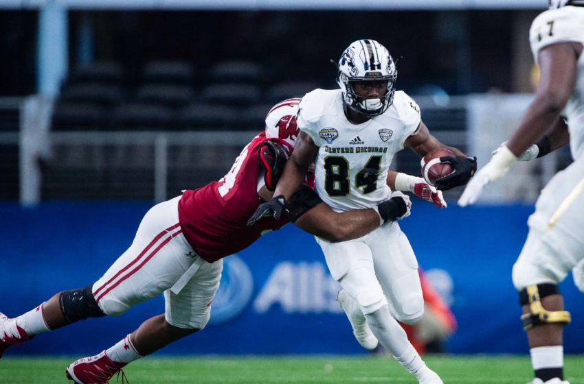 Jan 2, 2017; Arlington, TX, USA; Wisconsin Badgers defensive end Chikwe Obasih (34) and Western Michigan Broncos wide receiver Corey Davis (84) in action in the 2017 Cotton Bowl game at AT&T Stadium. The Badgers defeat the Broncos 24-16. Mandatory Credit: Jerome Miron-USA TODAY Sports
