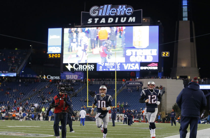 Jan 14, 2017; Foxborough, MA, USA; New England Patriots quarterbacks Jimmy Garoppolo (10) and Tom Brady (12) take the field before the AFC Divisional playoff game against the Houston Texans at Gillette Stadium. Mandatory Credit: David Butler III-USA TODAY Sports