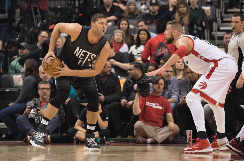 Jan 13, 2017; Toronto, Ontario, CAN; Brooklyn Nets center Brook Lopez (11) controls a ball as Toronto Raptors center Jonas Valanciunas (17) defends during the first quarter in a game at Air Canada Centre. The Toronto Raptors won 132-113. Mandatory Credit: Nick Turchiaro-USA TODAY Sports