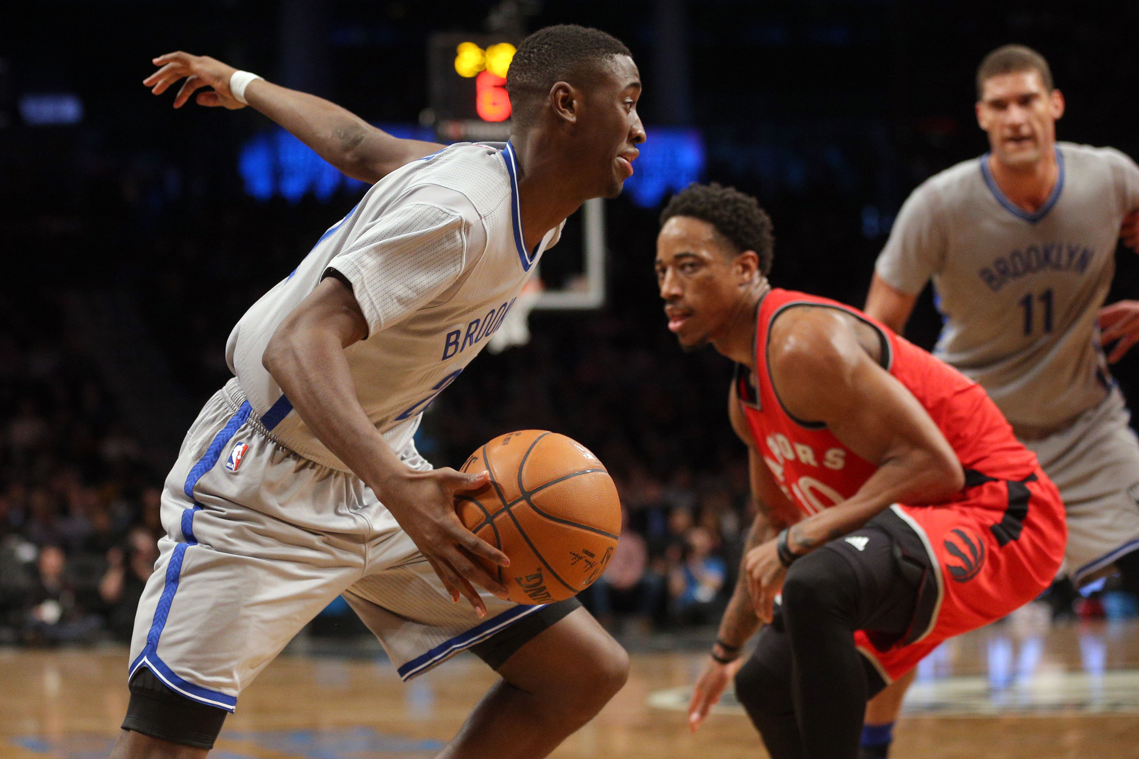 Jan 17, 2017; Brooklyn, NY, USA; Brooklyn Nets shooting guard Caris LeVert (22) drives past Toronto Raptors shooting guard DeMar DeRozan (10) during the third quarter at Barclays Center. Mandatory Credit: Brad Penner-USA TODAY Sports