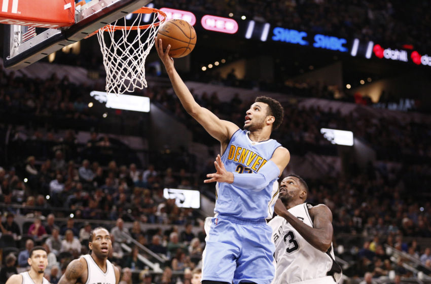Jan 19, 2017; San Antonio, TX, USA; Denver Nuggets shooting guard Jamal Murray (top) shoots the ball past San Antonio Spurs center Dewayne Dedmon (3) during the second half at AT&T Center. Mandatory Credit: Soobum Im-USA TODAY Sports