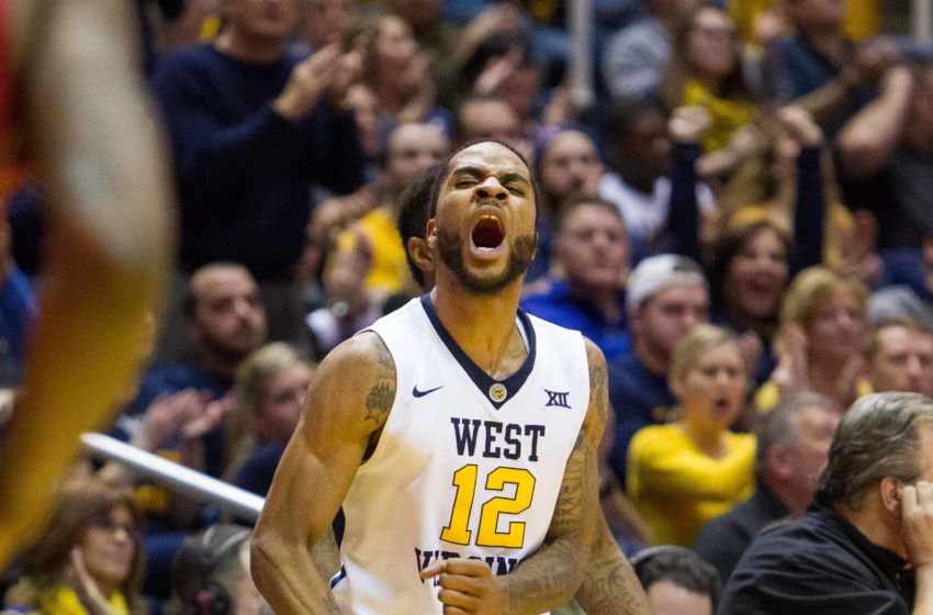Jan 18, 2017; Morgantown, WV, USA; West Virginia Mountaineers guard Tarik Phillip (12) celebrates from the bench during the second half against the Oklahoma Sooners at WVU Coliseum. Mandatory Credit: Ben Queen-USA TODAY Sports