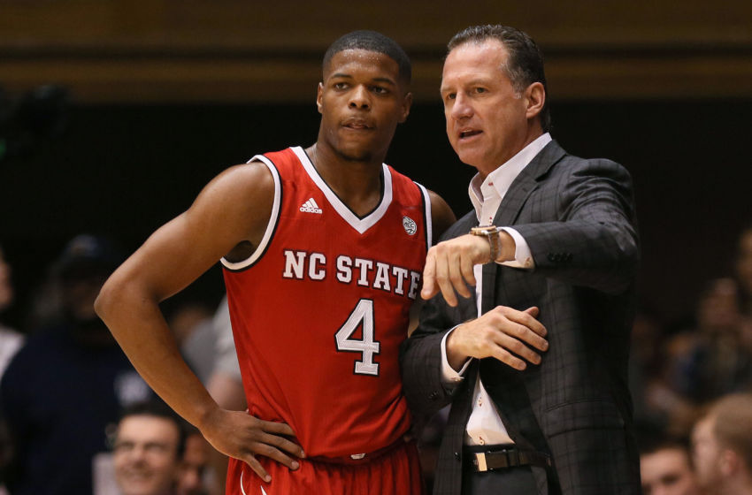Jan 23, 2017; Durham, NC, USA; North Carolina State Wolfpack head coach Mark Gottfried talks with guard Dennis Smith Jr. (4) on the sidelines in the first half of their game against the Duke Blue Devils at Cameron Indoor Stadium. Mandatory Credit: Mark Dolejs-USA TODAY Sports