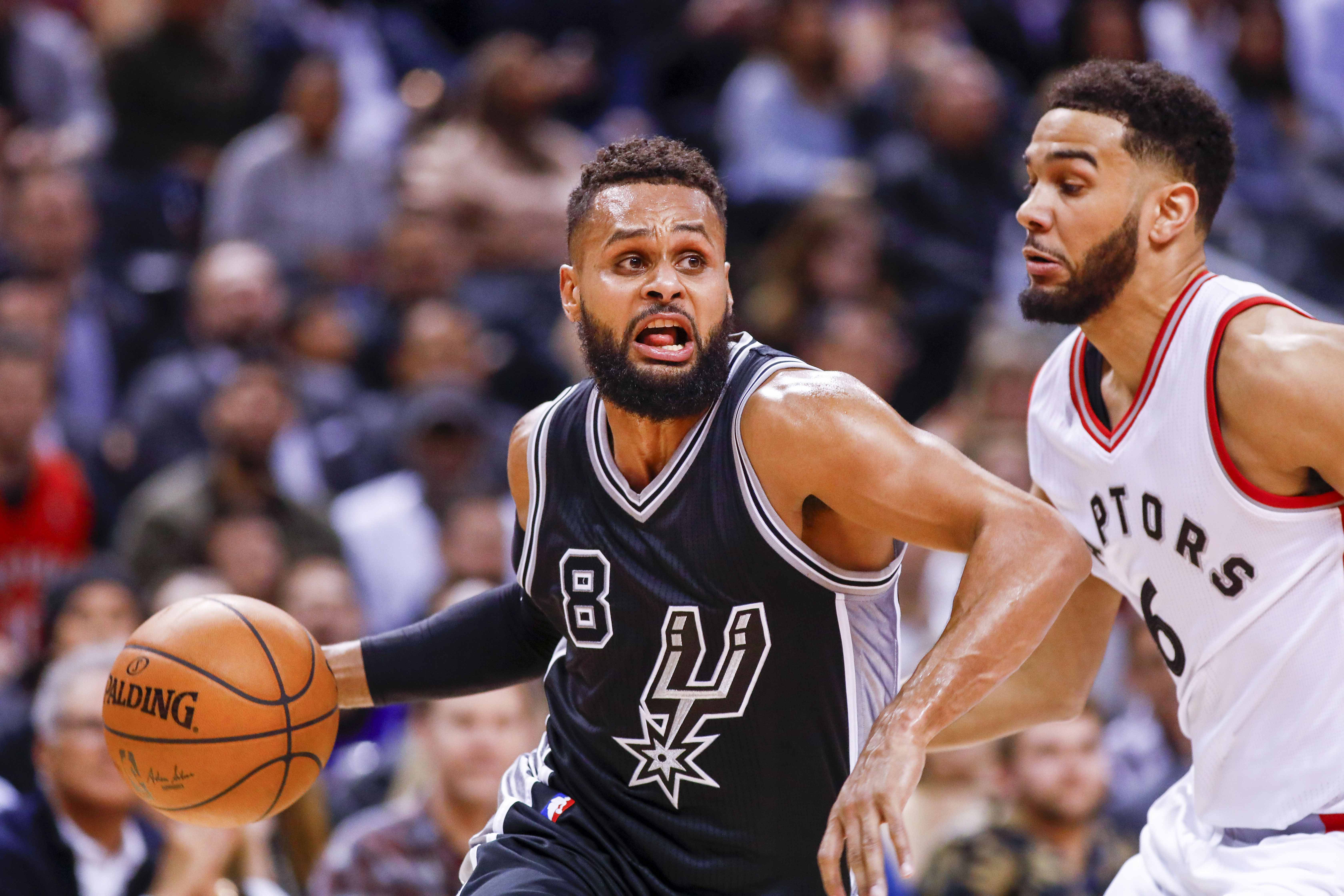 Jan 24, 2017; Toronto, Ontario, CAN; San Antonio Spurs guard Patty Mills (8) dribbles the all around Toronto Raptors guard Cory Joseph (6) in the second half at Air Canada Centre. Spurs defeat the Raptors 108-106. Mandatory Credit: Kevin Sousa-USA TODAY Sports
