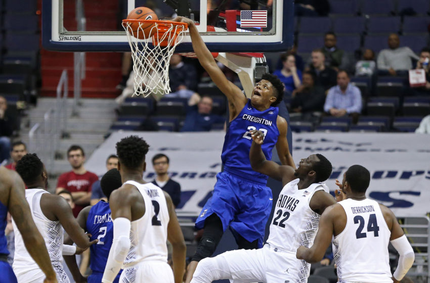 Jan 25, 2017; Washington, DC, USA; Creighton Bluejays center Justin Patton (23) dunks the ball as Georgetown Hoyas forward Akoy Agau (22) looks on in the second half at Verizon Center. The Hoyas won 71-51. Mandatory Credit: Geoff Burke-USA TODAY Sports