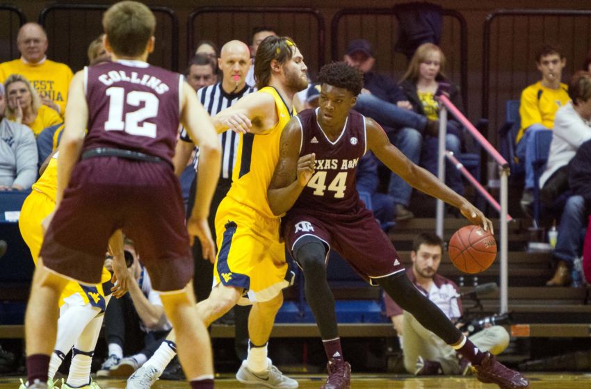 Jan 28, 2017; Morgantown, WV, USA; Texas A&M Aggies forward Robert Williams (44) backs down West Virginia Mountaineers forward Nathan Adrian (11) during the second half at WVU Coliseum. Mandatory Credit: Ben Queen-USA TODAY Sports