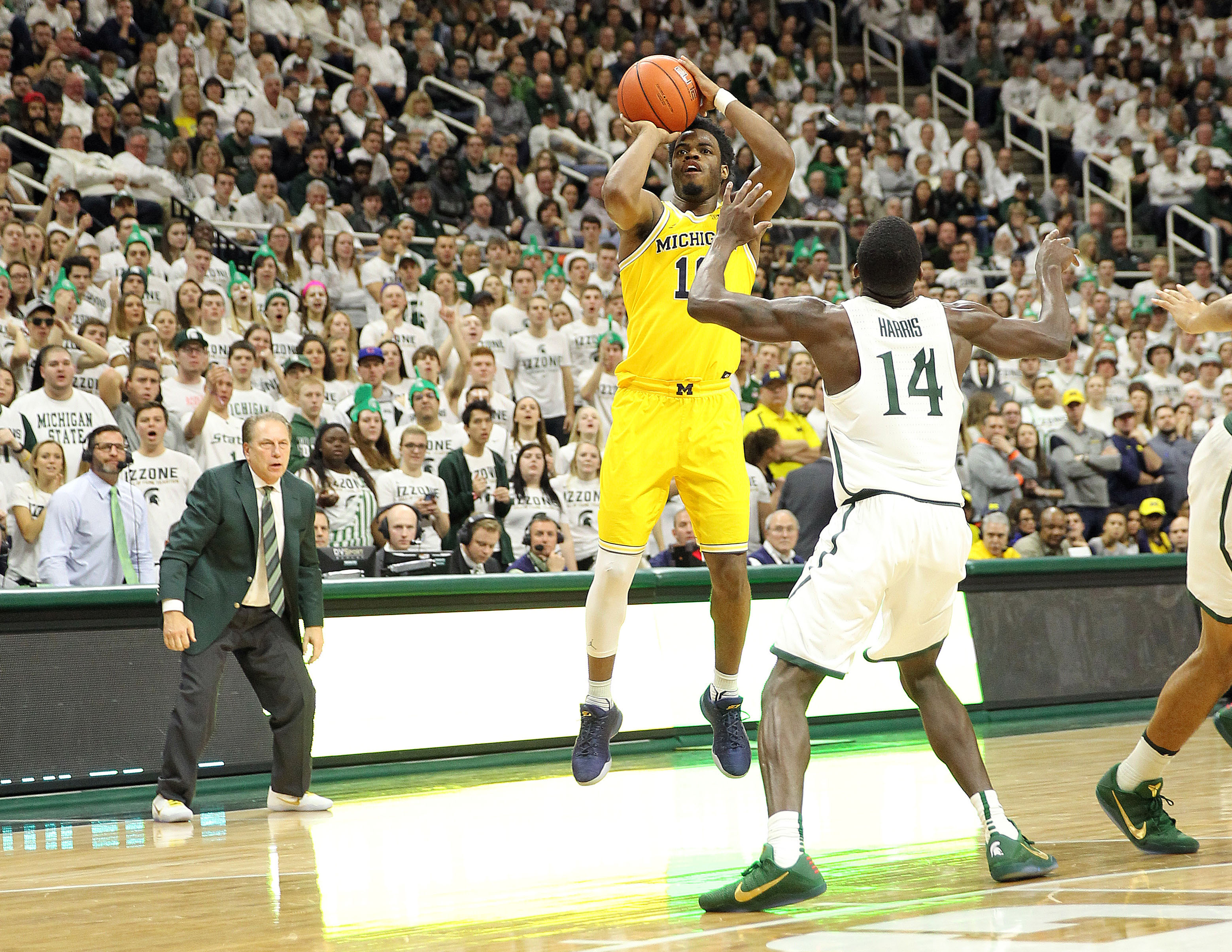 Jan 29, 2017; East Lansing, MI, USA; Michigan Wolverines guard Derrick Walton Jr. shoots against Michigan State Spartans guard Eron Harris during the first half of a game at the Jack Breslin Student Events Center. Mandatory Credit: Mike Carter-USA TODAY Sports