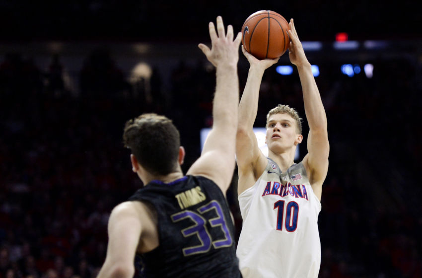 Jan 29, 2017; Tucson, AZ, USA; Arizona Wildcats forward Lauri Markkanen (10) shoots the ball as Washington Huskies forward Sam Timmins (33) defends during the second half at McKale Center. Arizona won 77-66. Mandatory Credit: Casey Sapio-USA TODAY Sports