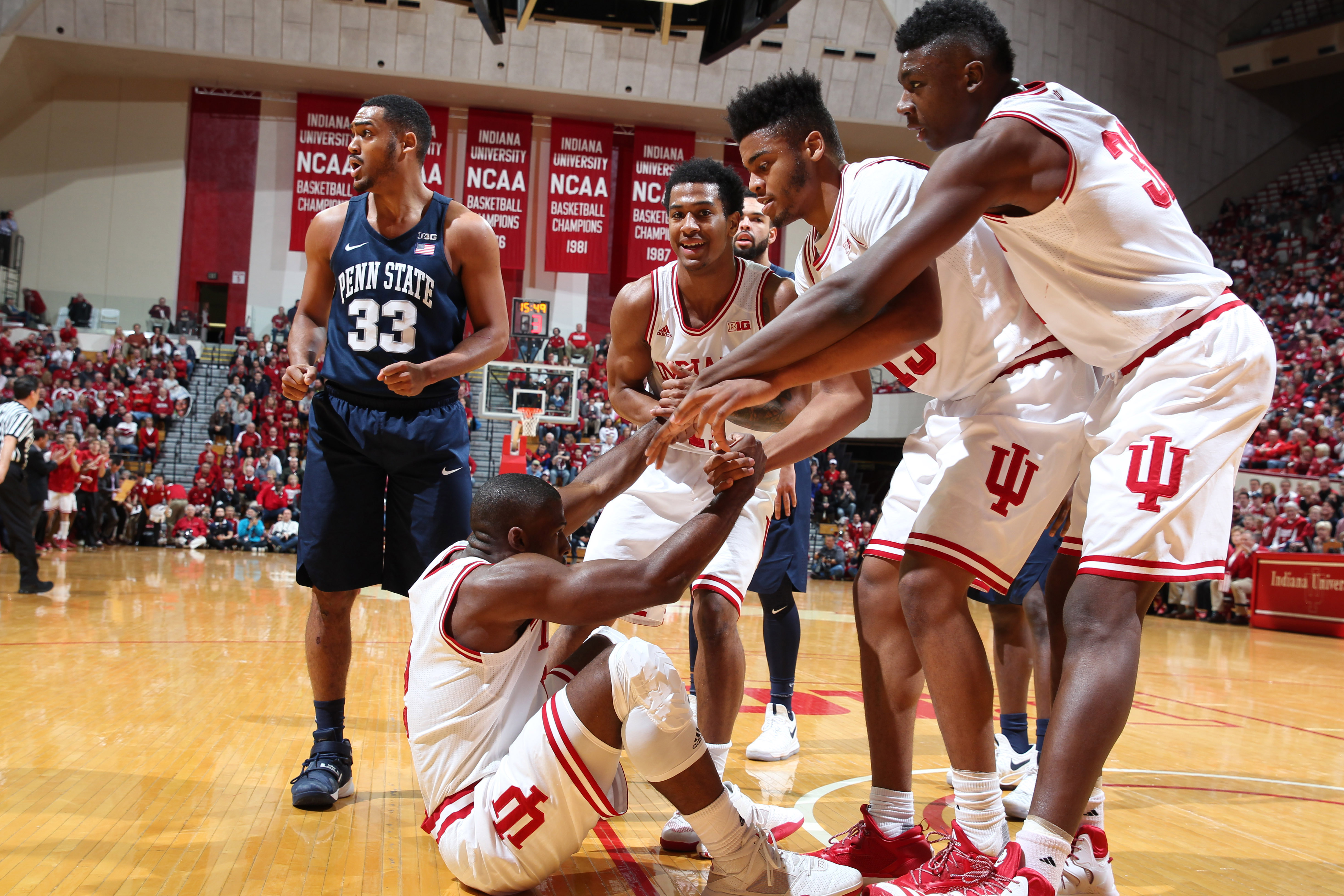 Feb 1, 2017; Bloomington, IN, USA; Indiana Hoosiers guard Josh Newkirk (2) gets helped up off the floor from center Thomas Bryant (31) and forward Juwan Morgan (13) against the Penn State Nittany Lions at Assembly Hall. Mandatory Credit: Brian Spurlock-USA TODAY Sports