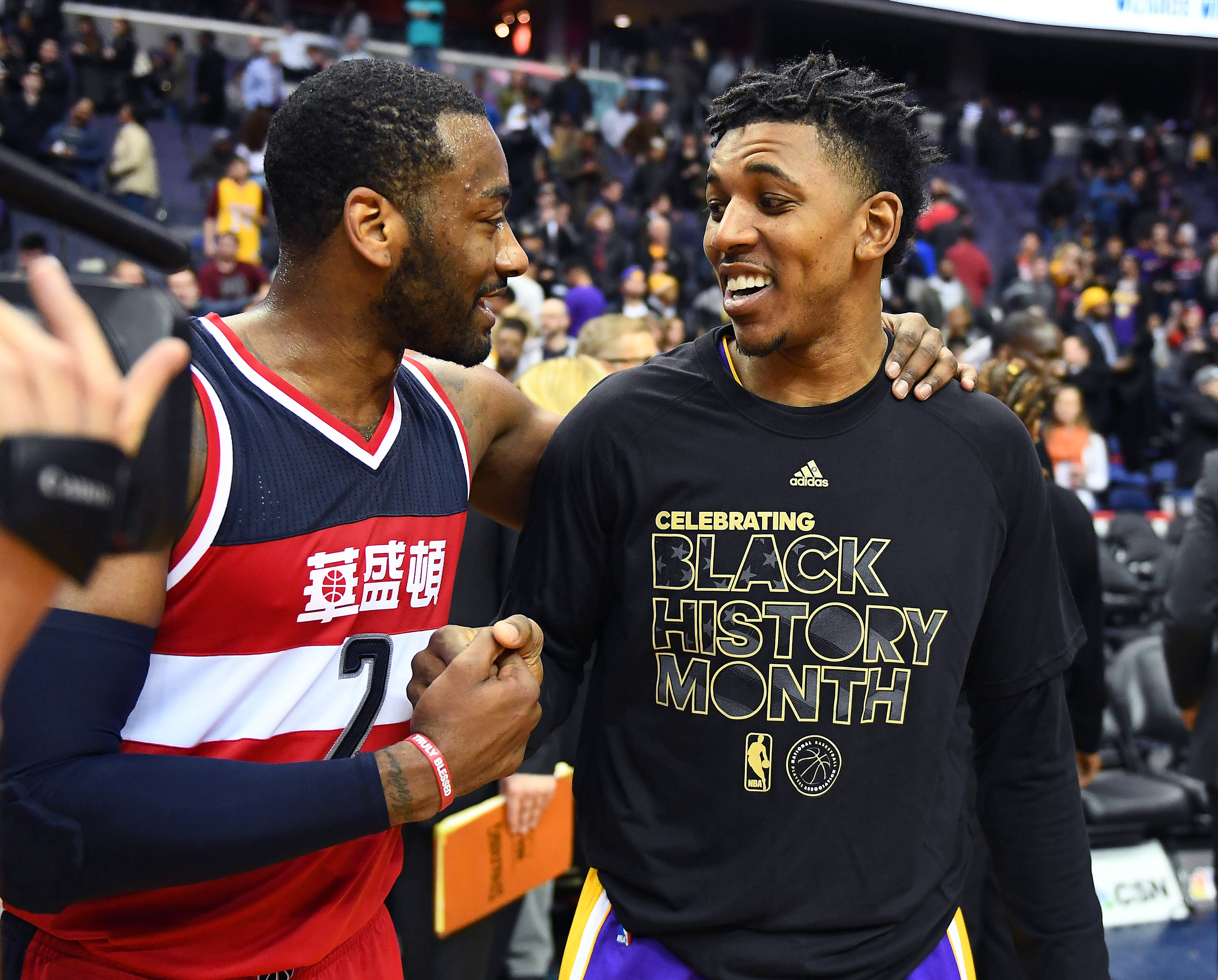 Feb 2, 2017; Washington, DC, USA; Washington Wizards guard John Wall (2) talks with Los Angeles Lakers guard Nick Young (0) after the game at Verizon Center. Washington Wizards won 116 - 108. Mandatory Credit: Brad Mills-USA TODAY Sports