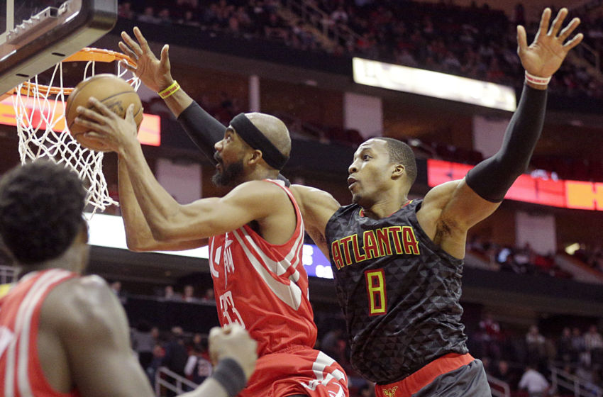 Feb 2, 2017; Houston, TX, USA; Houston Rockets forward Corey Brewer (33) drives against Atlanta Hawks center Dwight Howard (8) in the second half at Toyota Center. Atlanta Hawks won 113 to 108. Mandatory Credit: Thomas B. Shea-USA TODAY Sports