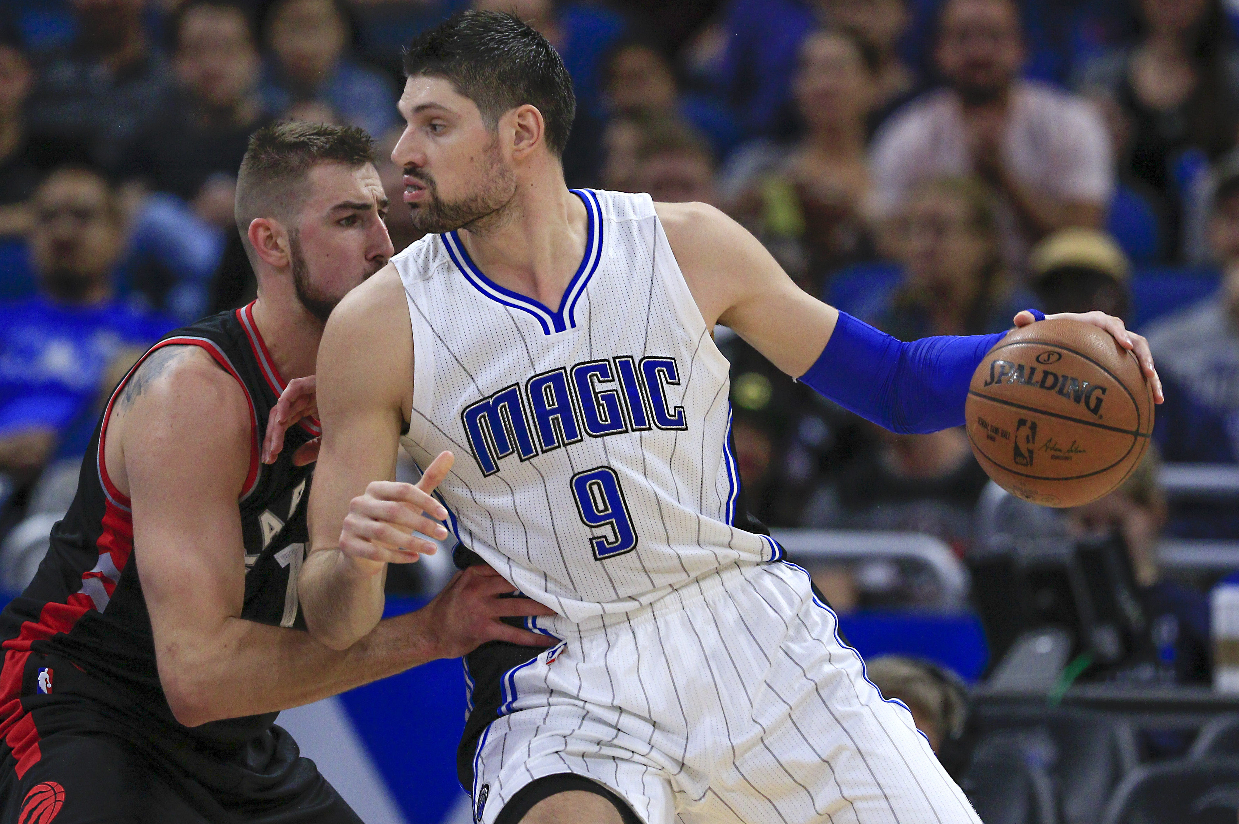 Feb 3, 2017; Orlando, FL, USA; Orlando Magic center Nikola Vucevic (9) dribbles the ball as Toronto Raptors center Jonas Valanciunas (17) defends during the second quarter of an NBA basketball game at Amway Center. Mandatory Credit: Reinhold Matay-USA TODAY Sports