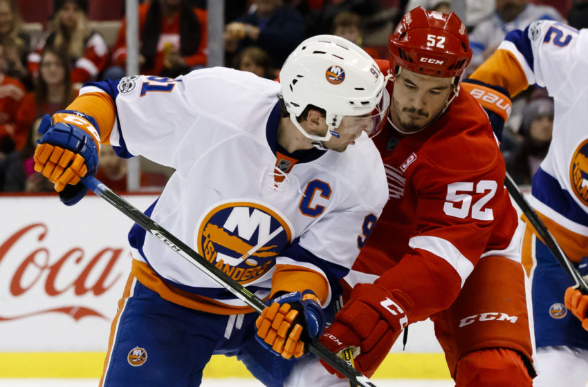 Feb 3, 2017; Detroit, MI, USA; New York Islanders center John Tavares (91) and Detroit Red Wings defenseman Jonathan Ericsson (52) battle for the puck in the second period at Joe Louis Arena. Mandatory Credit: Rick Osentoski-USA TODAY Sports