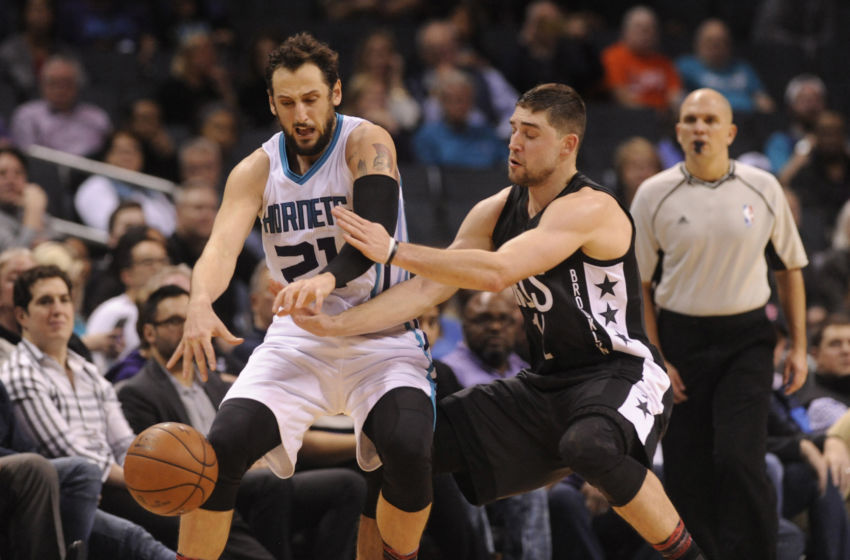 Feb 7, 2017; Charlotte, NC, USA; Charlotte Hornets guard forward Marco Belinelli (21) attempts to control the ball while being fouled by Brooklyn Nets guard Joe Harris (12) during the second half of the game at the Spectrum Center. The Hornets won 111-107. Mandatory Credit: Sam Sharpe-USA TODAY Sports