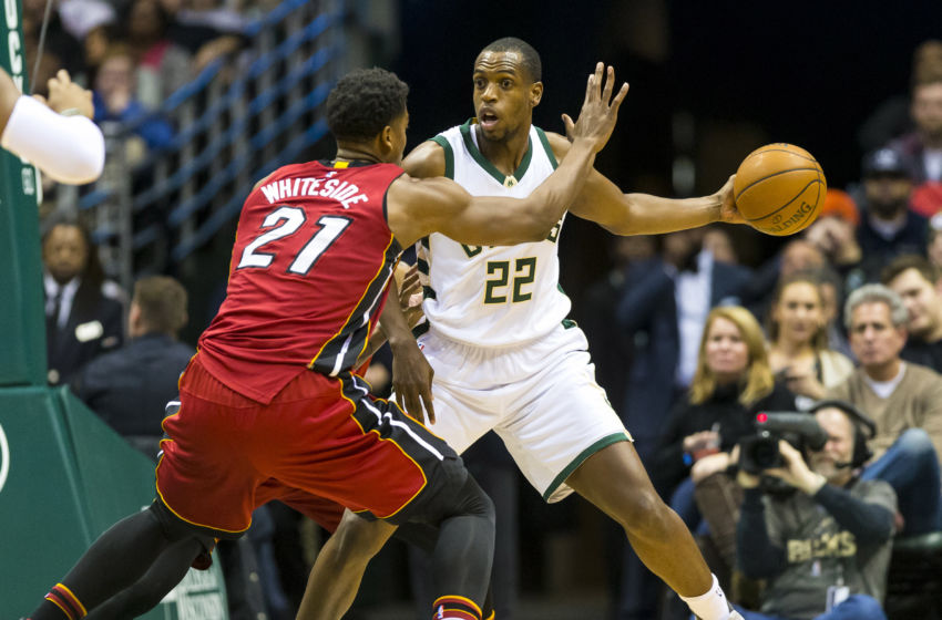 Feb 8, 2017; Milwaukee, WI, USA; Milwaukee Bucks guard Khris Middleton (22) passes the ball around Miami Heat center Hassan Whiteside (21) during the first quarter at BMO Harris Bradley Center. Mandatory Credit: Jeff Hanisch-USA TODAY Sports