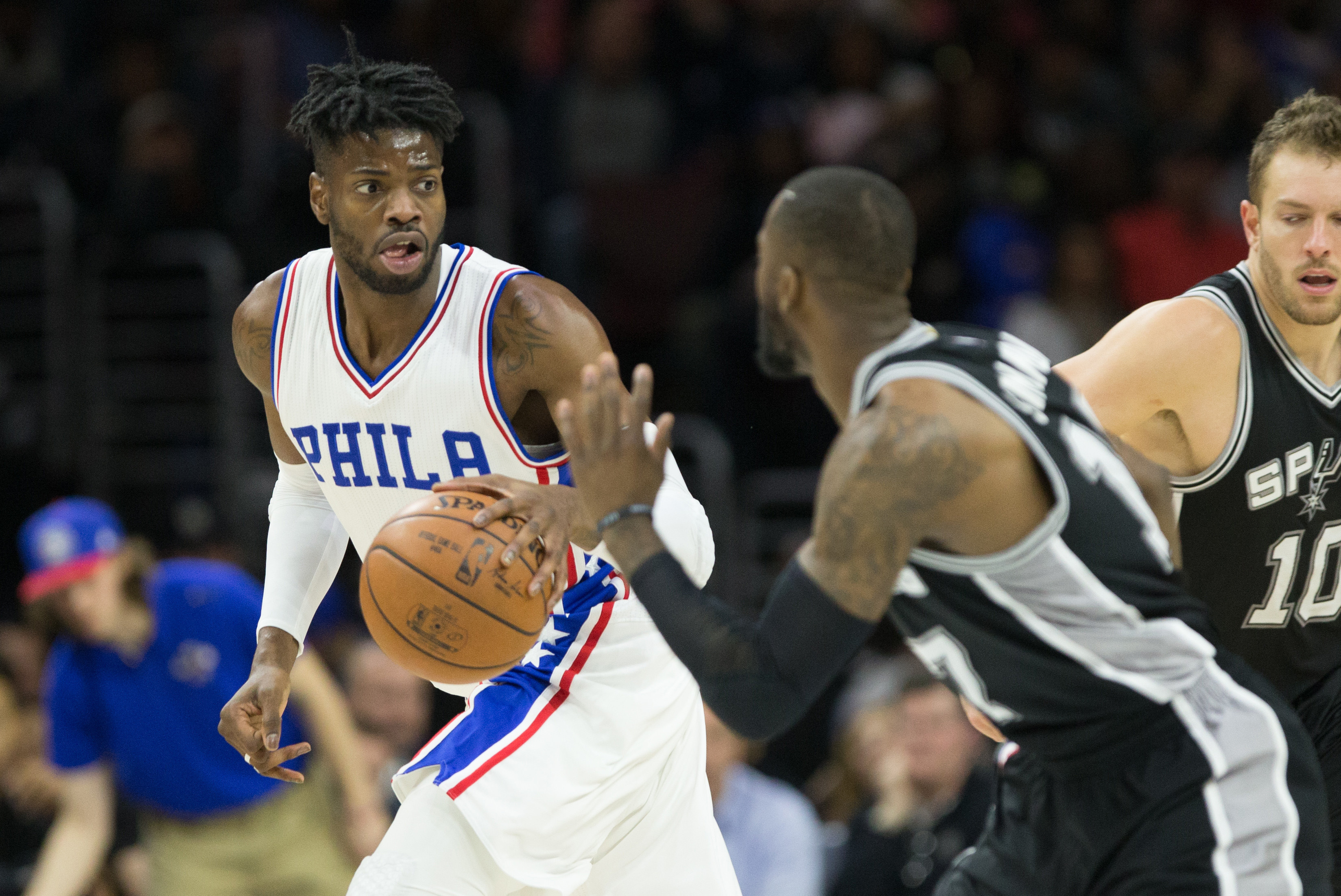 Feb 8, 2017; Philadelphia, PA, USA; Philadelphia 76ers forward Nerlens Noel (4) dribbles past San Antonio Spurs guard Jonathon Simmons (17) during the third quarter at Wells Fargo Center. The San Antonio Spurs won 111-103. Mandatory Credit: Bill Streicher-USA TODAY Sports