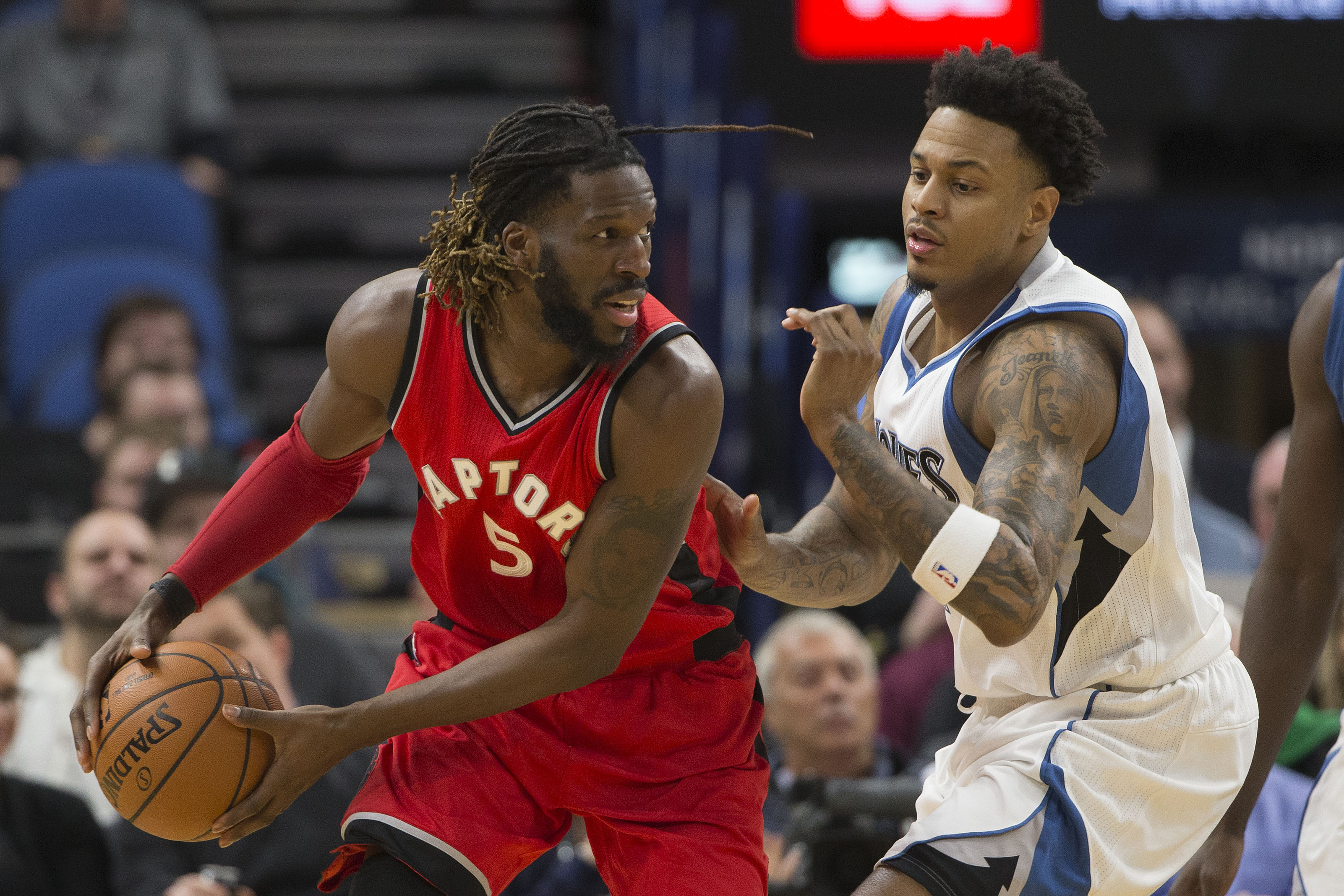 Feb 8, 2017; Minneapolis, MN, USA; Toronto Raptors forward DeMarre Carroll (5) looks to pass the ball around Minnesota Timberwolves guard Brandon Rush (4) in the second half at Target Center. The Timberwolves won 112-109. Mandatory Credit: Jesse Johnson-USA TODAY Sports