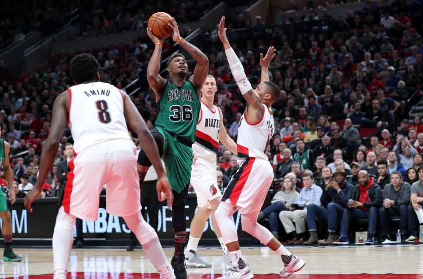 Feb 9, 2017; Portland, OR, USA; Boston Celtics guard Marcus Smart (36) shoots in between Portland Trail Blazers forward Al-Farouq Aminu (8) and guard Damian Lillard (0) in the second half at Moda Center. Mandatory Credit: Jaime Valdez-USA TODAY Sports