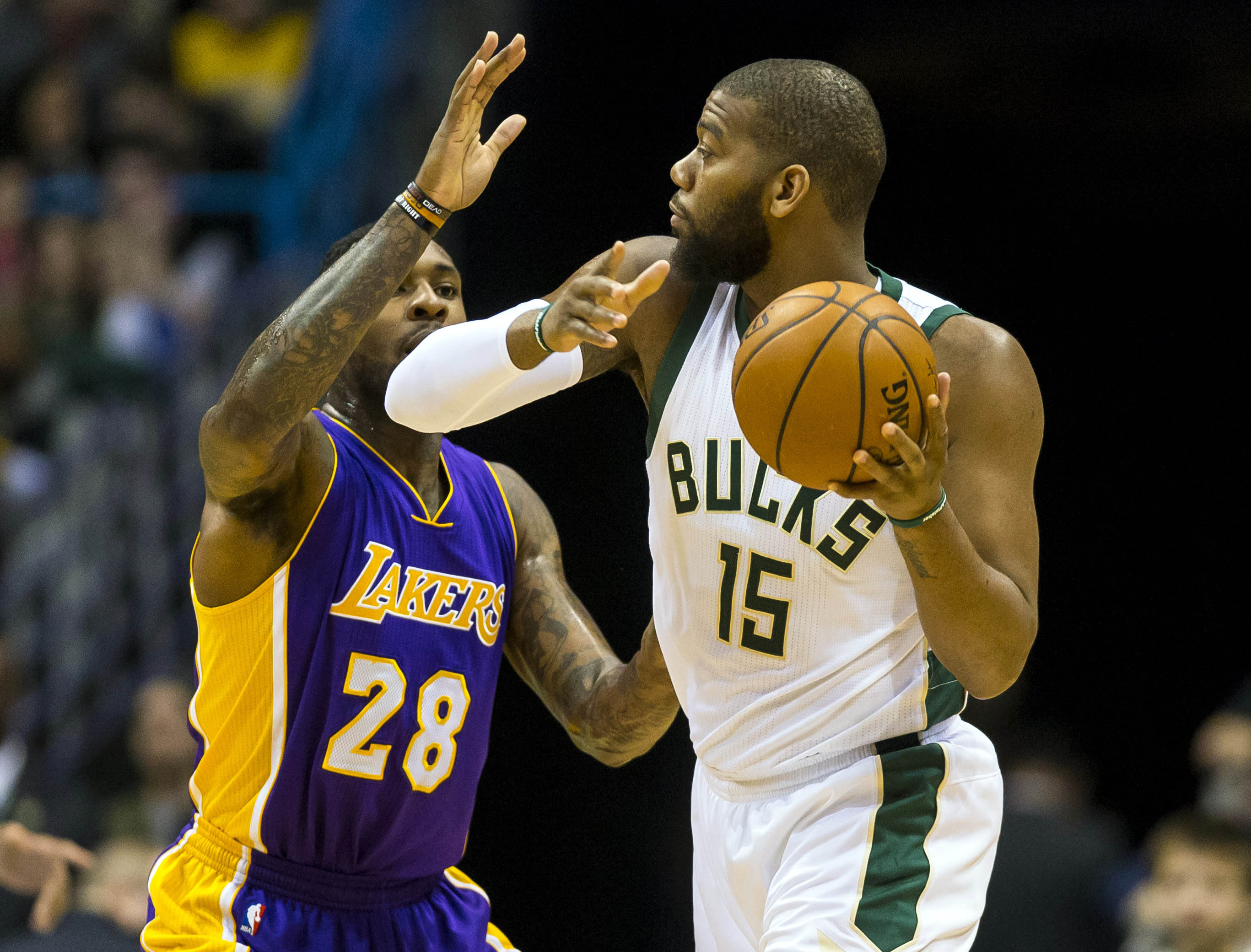 Feb 10, 2017; Milwaukee, WI, USA; Milwaukee Bucks center Greg Monroe (15) looks to pass the ball under pressure from Los Angeles Lakers center Tarik Black (28) during the first quarter at BMO Harris Bradley Center. Mandatory Credit: Jeff Hanisch-USA TODAY Sports