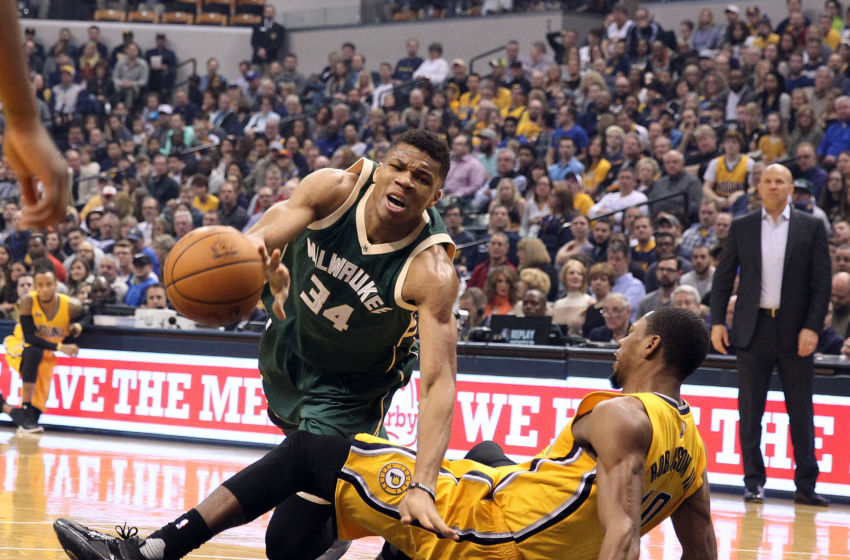 Feb 11, 2017; Indianapolis, IN, USA; Milwaukee Bucks forward Giannis Antetokounmpo (34) draws a blocking foul against Indiana Pacers forward Glenn Robinson III (40) at Bankers Life Fieldhouse. Mandatory Credit: Brian Spurlock-USA TODAY Sports