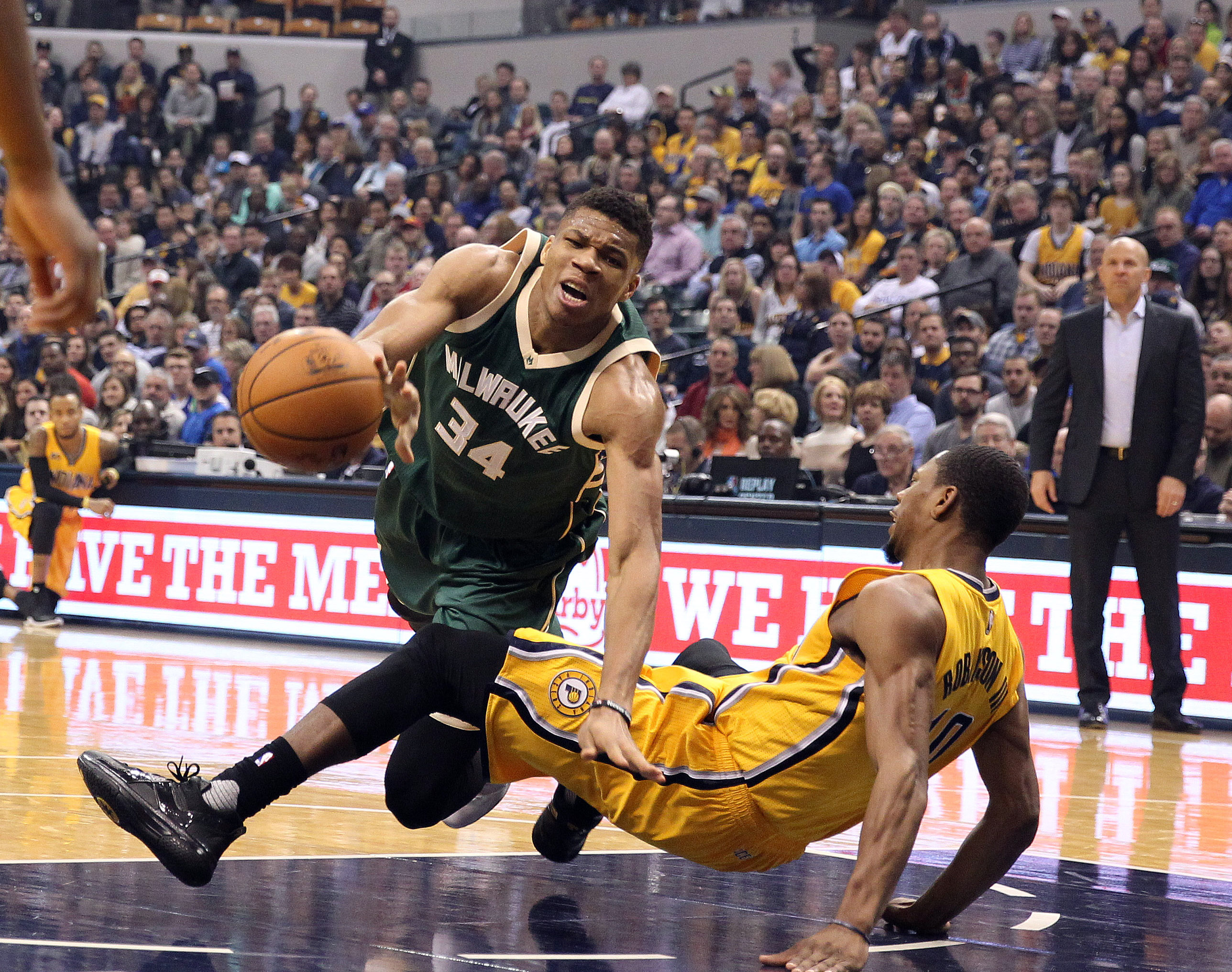 Feb 11, 2017; Indianapolis, IN, USA; Milwaukee Bucks forward Giannis Antetokounmpo (34) draws a blocking foul against Indiana Pacers forward Glenn Robinson III (40) at Bankers Life Fieldhouse. Mandatory Credit: Brian Spurlock-USA TODAY Sports