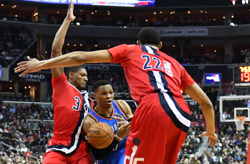 Feb 13, 2017; Washington, DC, USA; Oklahoma City Thunder guard Russell Westbrook (0) looks to pass as Washington Wizards guard Bradley Beal (3) and forward Otto Porter Jr. (22) defend during the first quarter at Verizon Center. Mandatory Credit: Tommy Gilligan-USA TODAY Sports