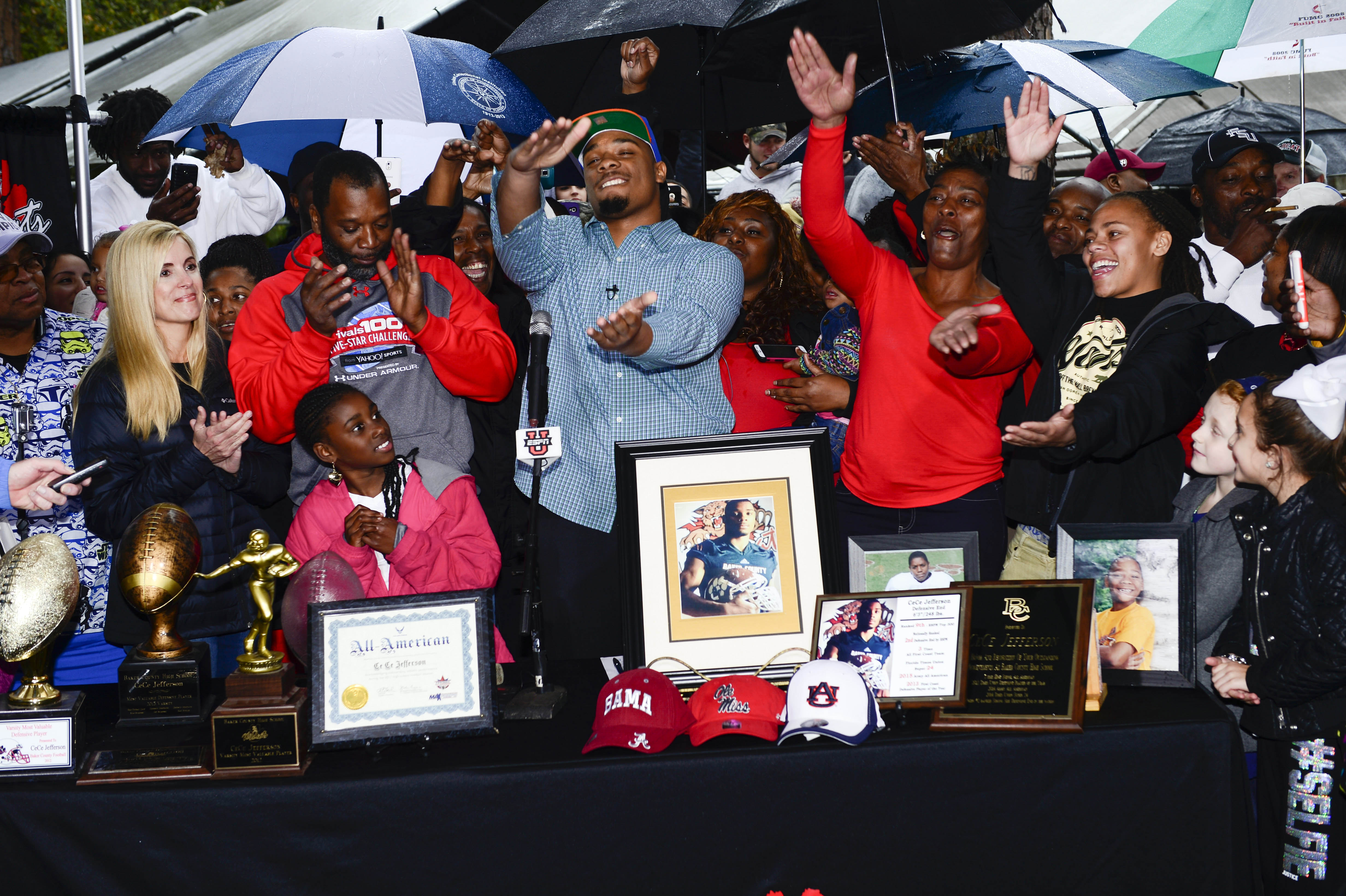 Feb 4, 2015; Glen Saint Mary, FL, USA; Ce Ce Jefferson signs with the University of Florida at his home near Baker County High School as his parents Leo and Annette Jefferson look on. Mandatory Credit: Richard Dole-USA TODAY Sports