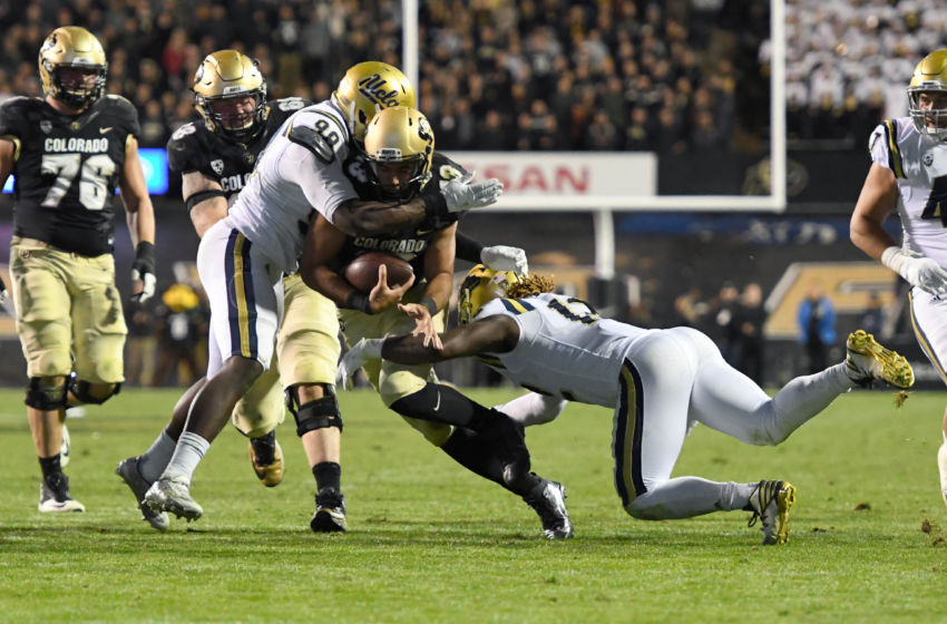 Nov 3, 2016; Boulder, CO, USA; UCLA Bruins defensive lineman Takkarist McKinley (98) and linebacker Jayon Brown (12) tackle the scramble of Colorado Buffaloes quarterback Sefo Liufau (13) in the first half at Folsom Field. Mandatory Credit: Ron Chenoy-USA TODAY Sports