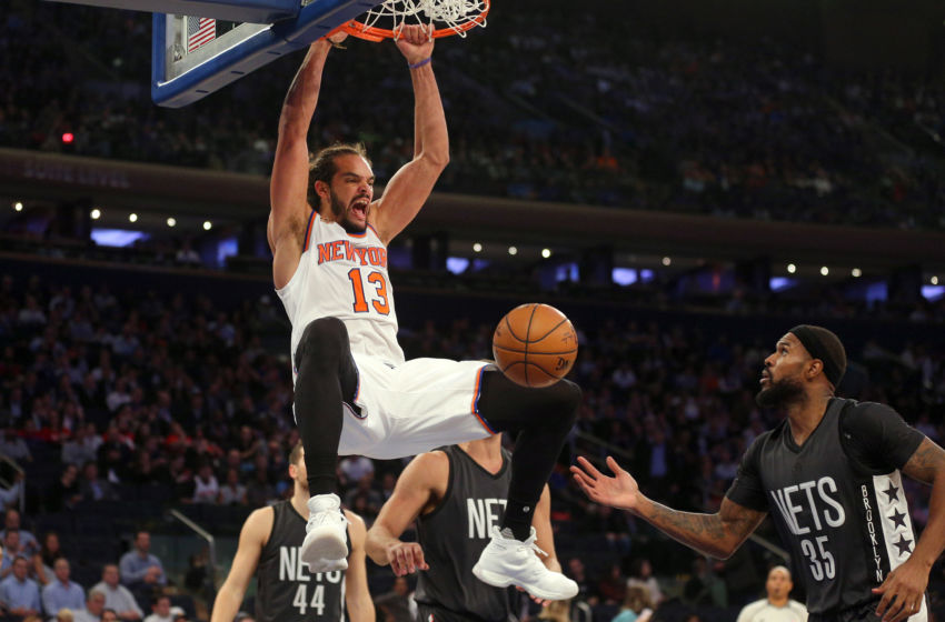 Nov 9, 2016; New York, NY, USA; New York Knicks center Joakim Noah (13) dunks over Brooklyn Nets center Brook Lopez (11) and Brooklyn Nets power forward Trevor Booker (35) during the third quarter at Madison Square Garden. Mandatory Credit: Brad Penner-USA TODAY Sports