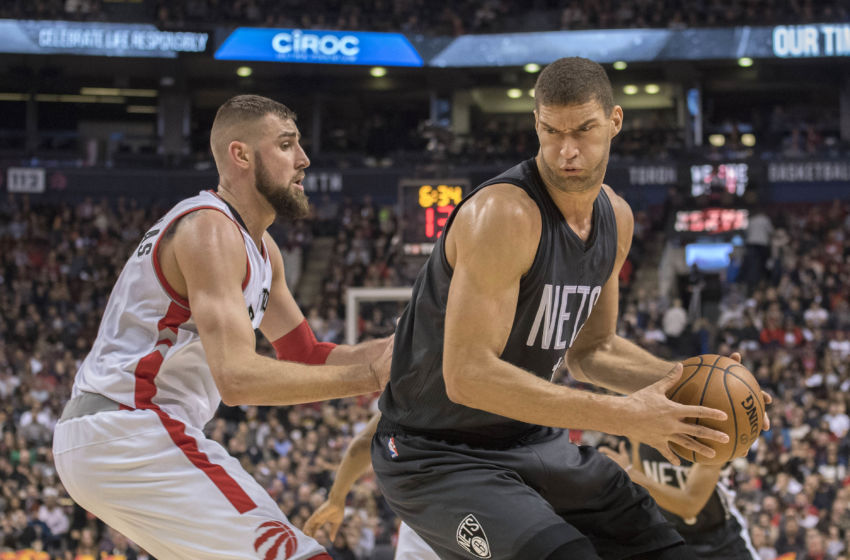 Jan 13, 2017; Toronto, Ontario, CAN; Brooklyn Nets center Brook Lopez (11) controls a ball as Toronto Raptors center Jonas Valanciunas (17) defends during the third quarter in a game at Air Canada Centre. The Toronto Raptors won 132-113. Mandatory Credit: Nick Turchiaro-USA TODAY Sports