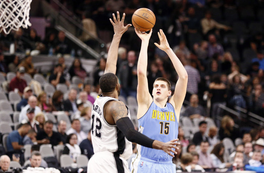 Jan 19, 2017; San Antonio, TX, USA; Denver Nuggets power forward Nikola Jokic (15) shoots the ball over San Antonio Spurs power forward LaMarcus Aldridge (12) during the second half at AT&T Center. Mandatory Credit: Soobum Im-USA TODAY Sports