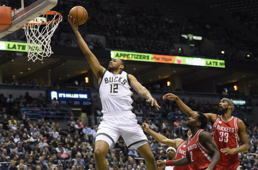 Jan 23, 2017; Milwaukee, WI, USA; Milwaukee Bucks forward Jabari Parker (12) takes a shot against Houston Rockets guard Patrick Beverley (2) in the fourth quarter at BMO Harris Bradley Center. The Bucks beat the Rockets 127-114. Mandatory Credit: Benny Sieu-USA TODAY Sports