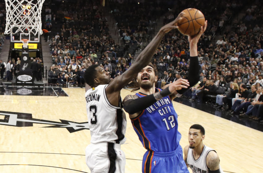 Jan 31, 2017; San Antonio, TX, USA; Oklahoma City Thunder center Steven Adams (12) shoots the ball as San Antonio Spurs center Dewayne Dedmon (3) defends during the second half at AT&T Center. The Spurs won 108-94. Mandatory Credit: Soobum Im-USA TODAY Sports