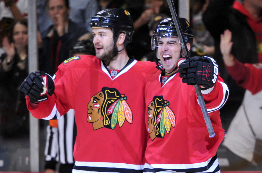 Oct 19, 2013; Chicago, IL, USA; Chicago Blackhawks center Brandon Pirri (right) celebrates scoring a goal with defenseman Brent Seabrook (left) against the Toronto Maple Leafs during the second period at the United Center. Mandatory Credit: Rob Grabowski-USA TODAY Sports