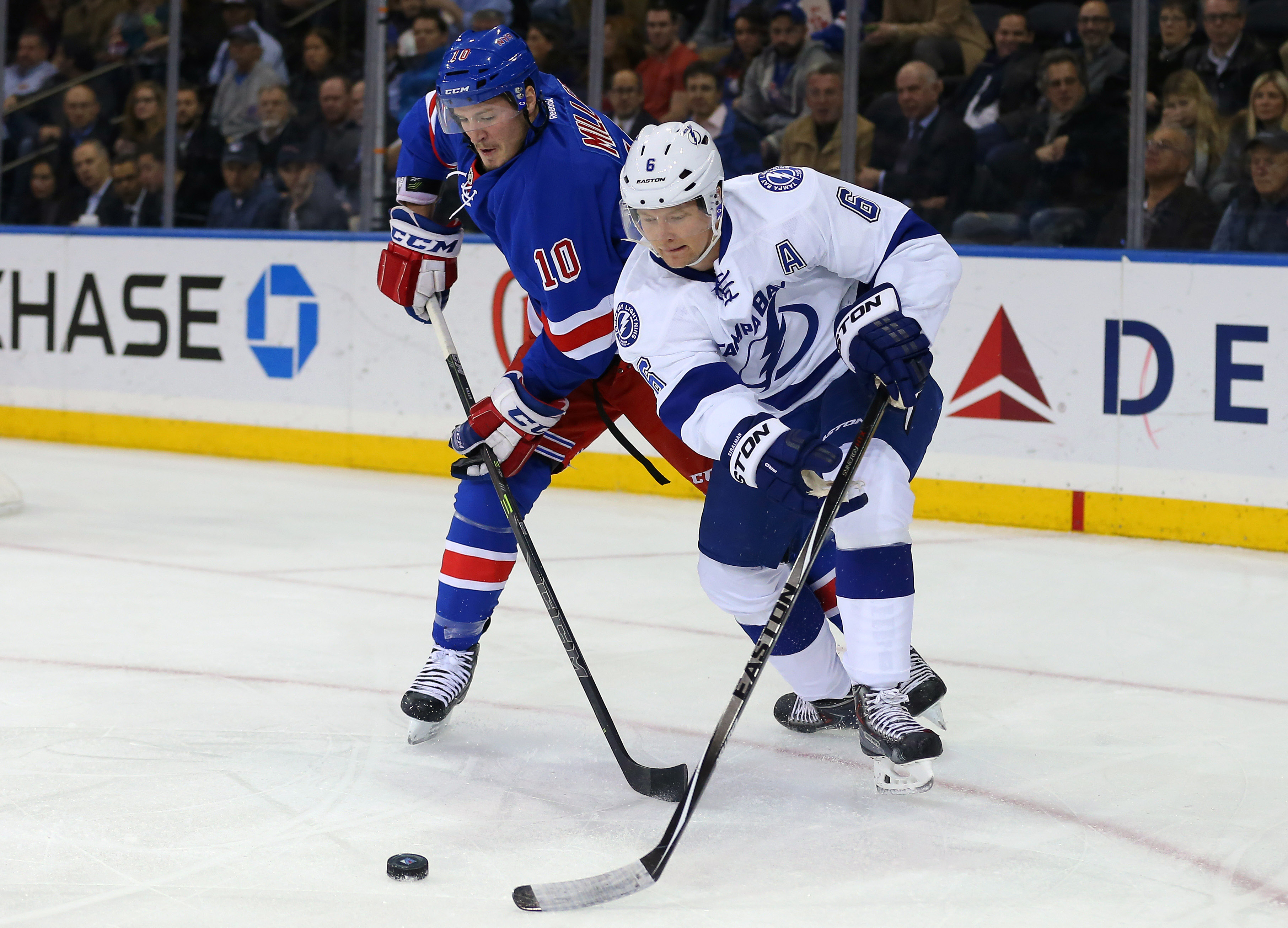 Dec 1, 2014; New York, NY, USA; Tampa Bay Lightning defenseman Anton Stralman (6) battles for the puck with New York Rangers center J.T. Miller (10) during the first period at Madison Square Garden. Mandatory Credit: Adam Hunger-USA TODAY Sports